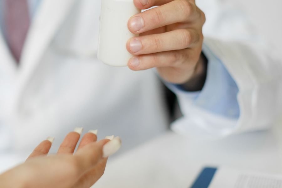 Handing over a bottle of tablets