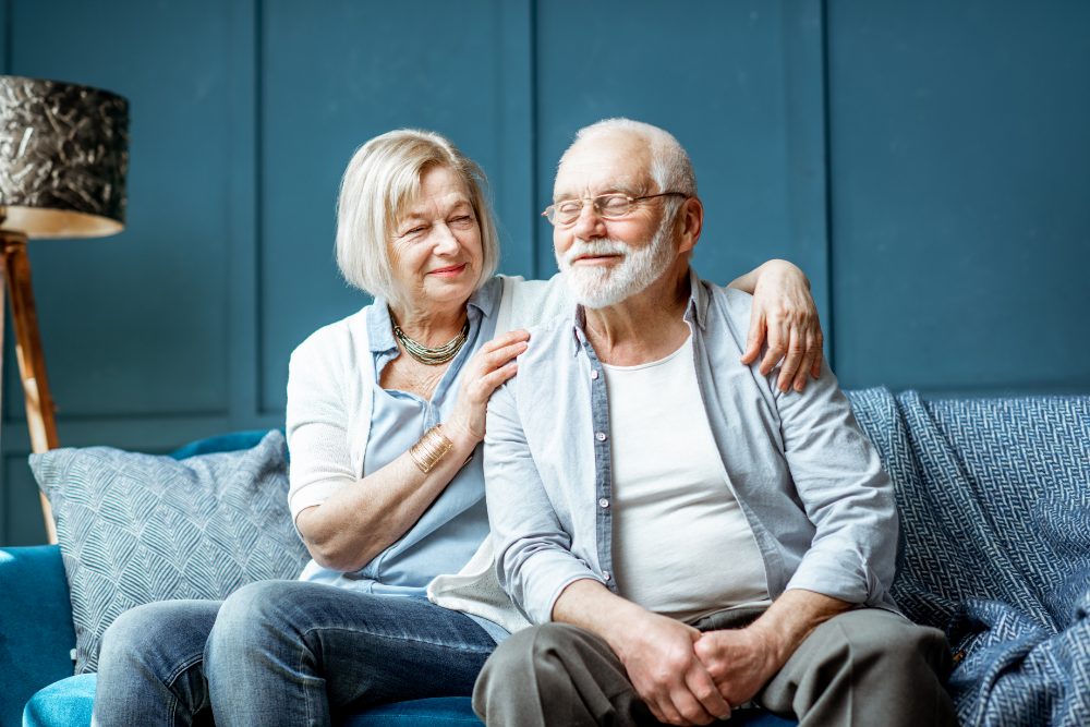 An older couple sitting together at home