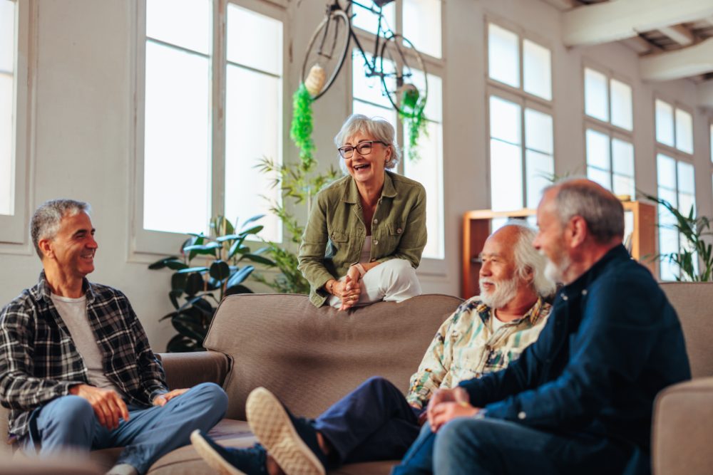 Older people talking together in a living room