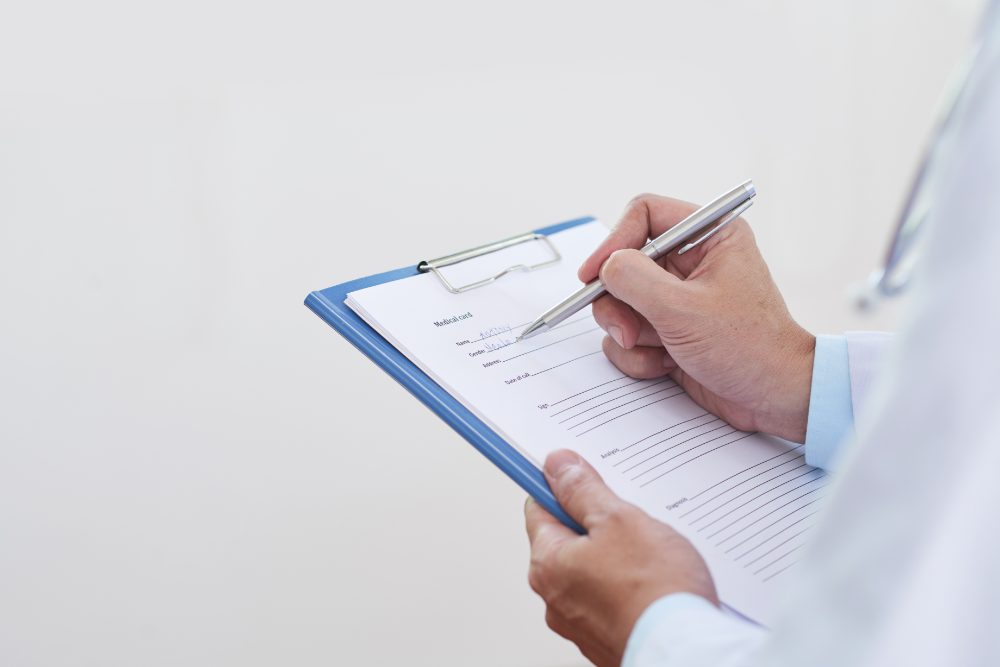 A doctor filling in a patient's medical record