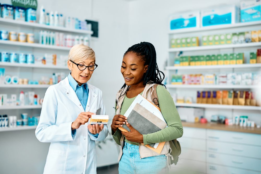 A pharmacist helping a customer choose a medicine