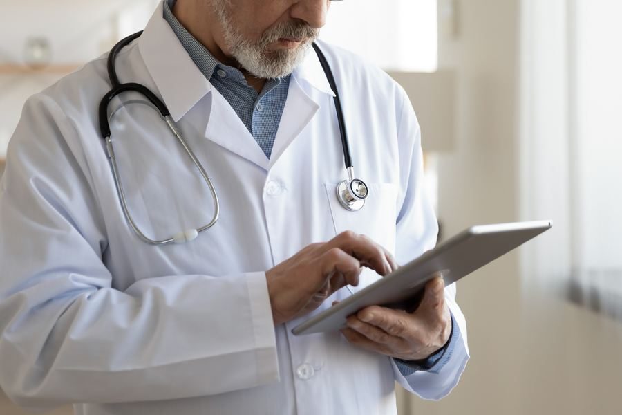 A clinician reviewing a medicines list on a tablet