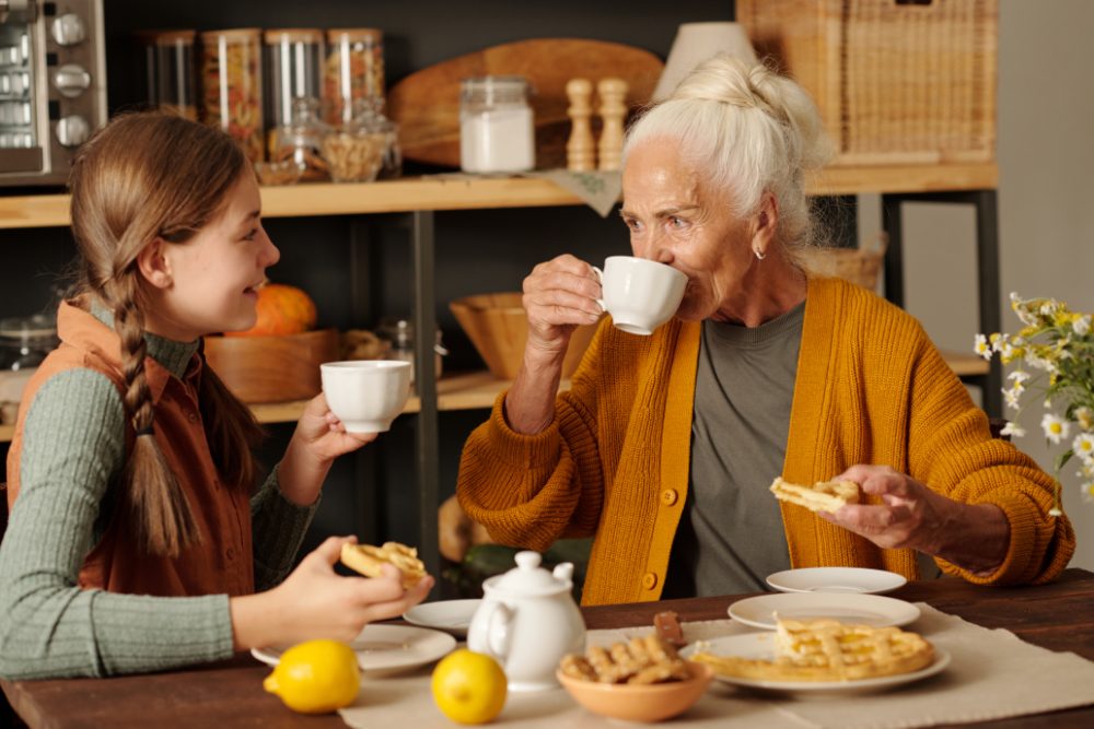 An older woman having tea at the kitchen table